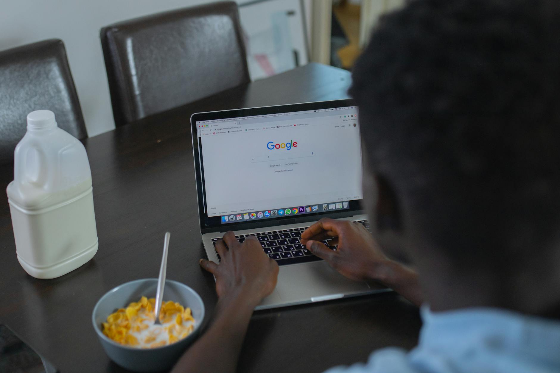 a person using google search engine on a laptop